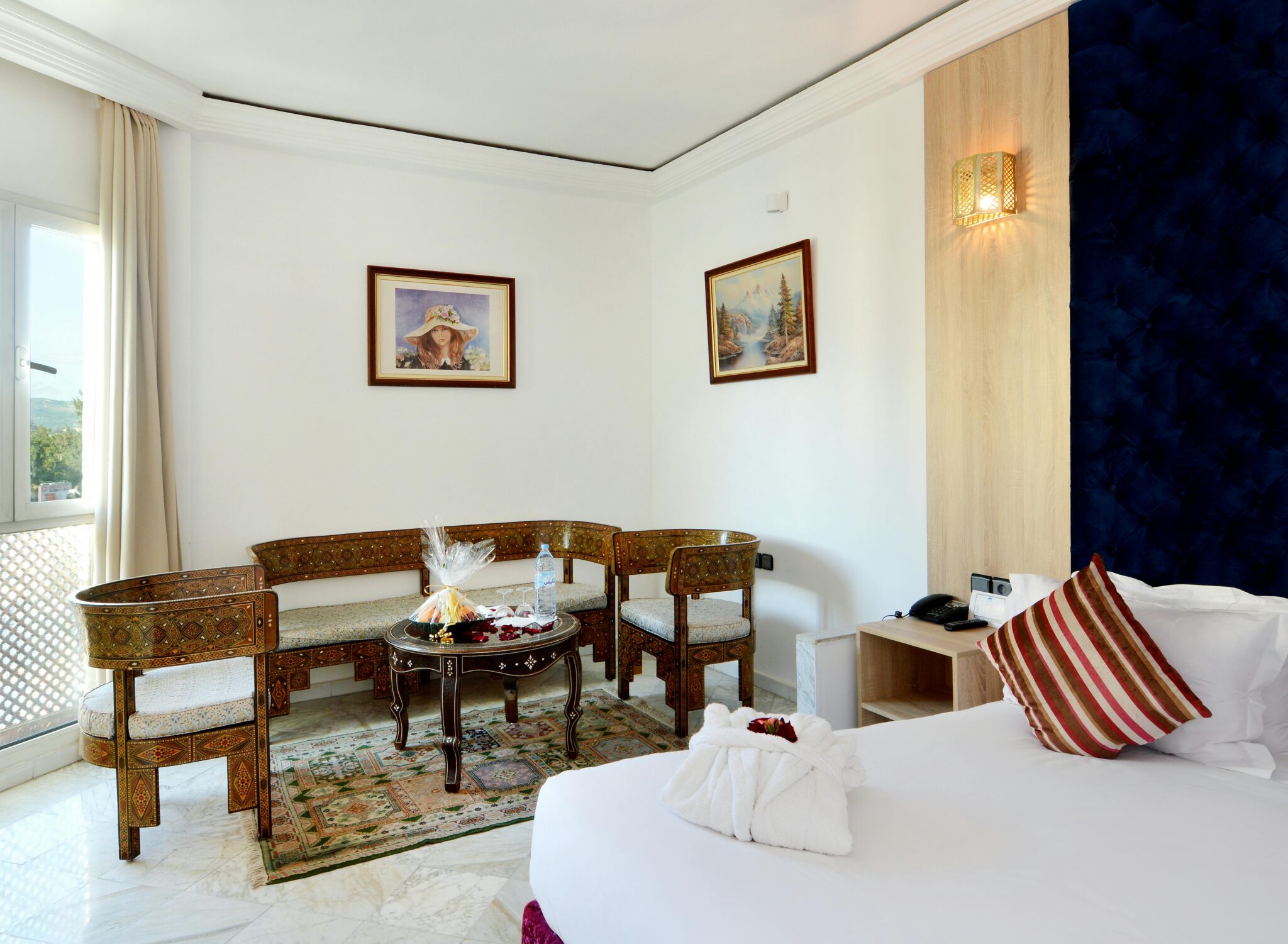 Bright hotel room with traditional furniture and modern amenities.